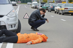 Road accident. Knock down pedestrian and upset driver in front o