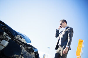 man-looking-at-crashed-car