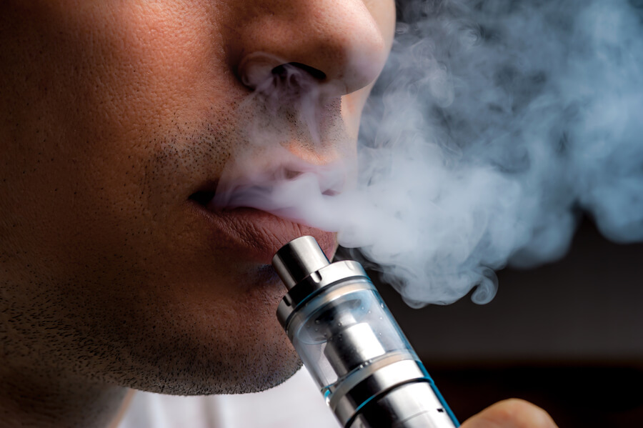 man vaping with e-cigarette